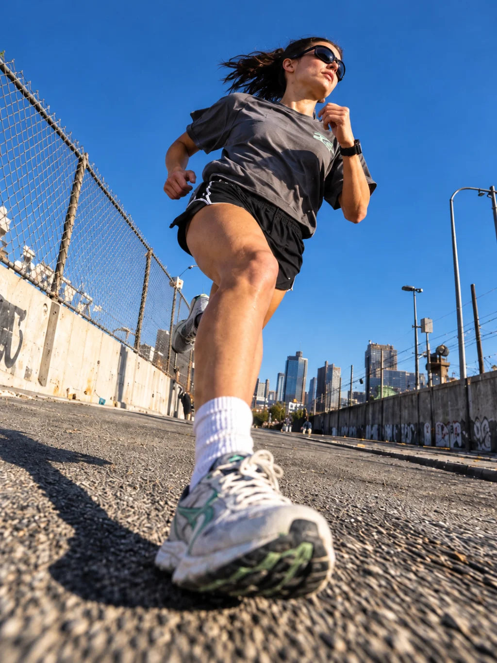 Woman running outdoors on a sunny day.